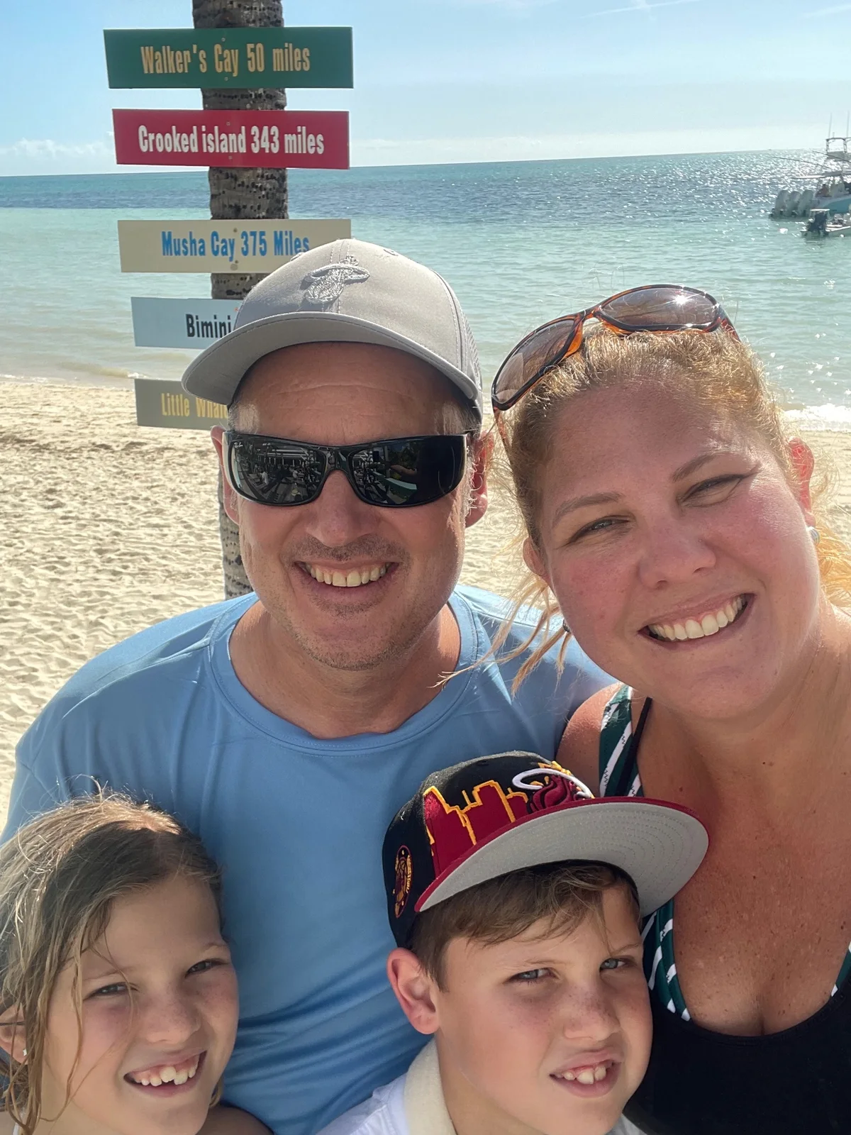 Pamela, Christoph and the children smiling together on a Grand Bahama beach