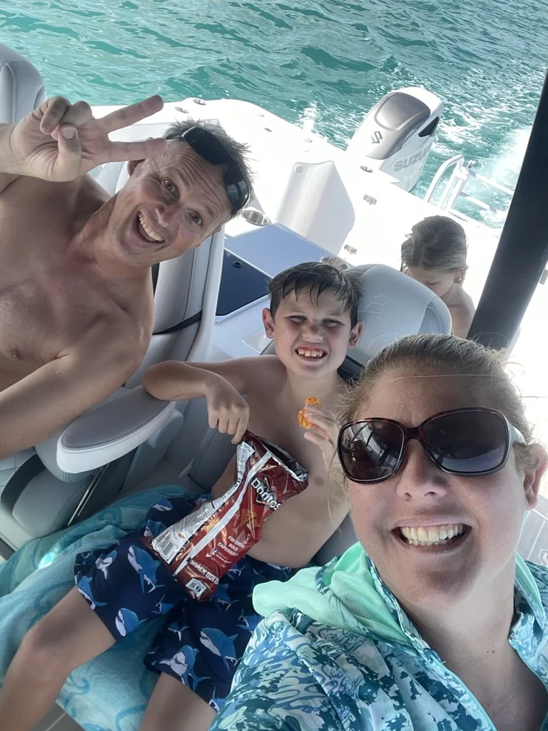 Pamela's family sharing snacks during a boat day
