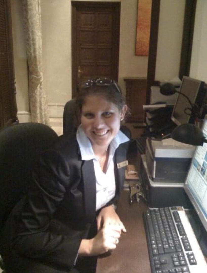 Pamela at a hotel office desk during the beginning of her hospitality career